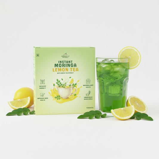 Instant Moringa Lemon Tea packaging with a glass of tea and lemon slices on a white background